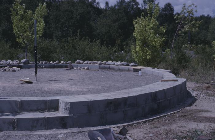 Low circular stone wall with stones gathered to build stone cairn to commemorate when at the 31st General Council former moderator Bob Smith Apologized to the Native people for years of rejecting Native spirituality