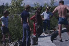 Elder Art Solomon, who is supervising the stone work on cairn, talks with some of the volunteers on the site, who are working on the construction