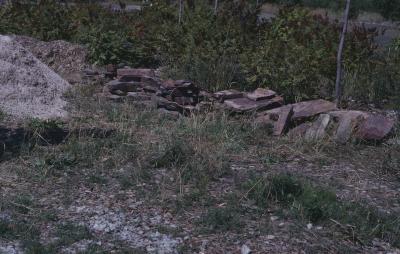 Rocks gathered from the nearby Whitefish Reserve to build circular stone wall to hold cairn.