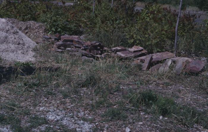 Rocks gathered from the nearby Whitefish Reserve to build circular stone wall to hold cairn.
