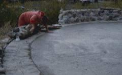 Maxine McVey of Sudbury helps with the construction and lays the stones on the circular stone wall [of the Apology cairn]