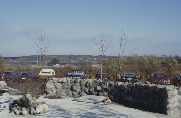 Construction of the low circular stone wall of [Apology cairn]