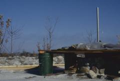 Construction of the low circular stone wall of [Apology cairn]