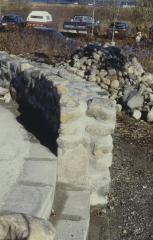 Construction of the low circular stone wall of [Apology cairn]