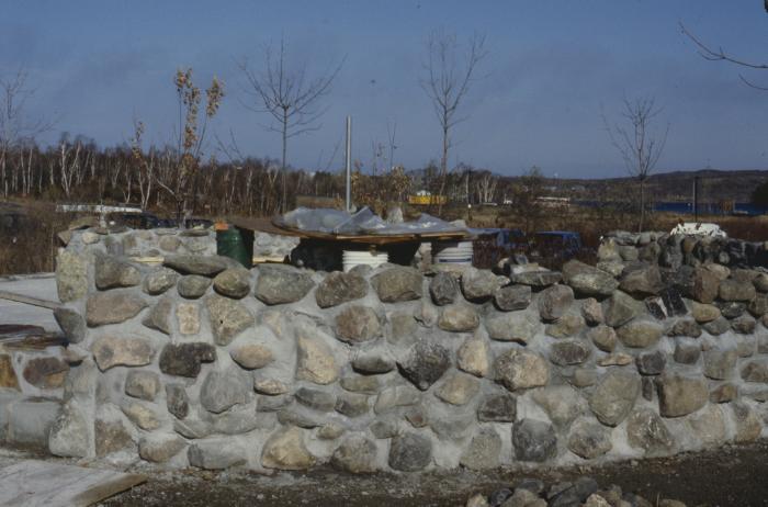 Construction of the low circular stone wall of [Apology cairn]