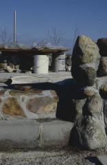 Construction of the low circular stone wall of [Apology cairn]