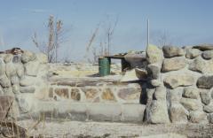 Construction of the low circular stone wall of [Apology cairn]