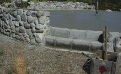Construction of the low circular stone wall of [Apology cairn]
