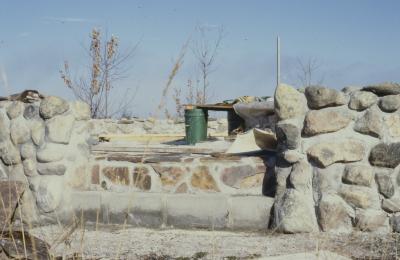 Construction of the low circular stone wall of [Apology cairn]
