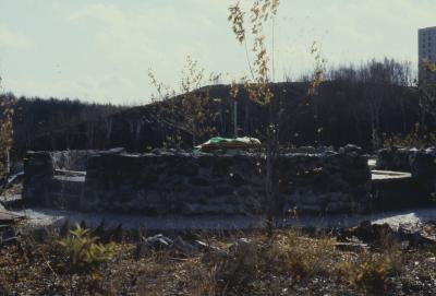 Construction of the low circular stone wall of [Apology cairn]