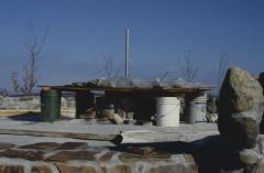 Construction of the low circular stone wall of [Apology cairn]